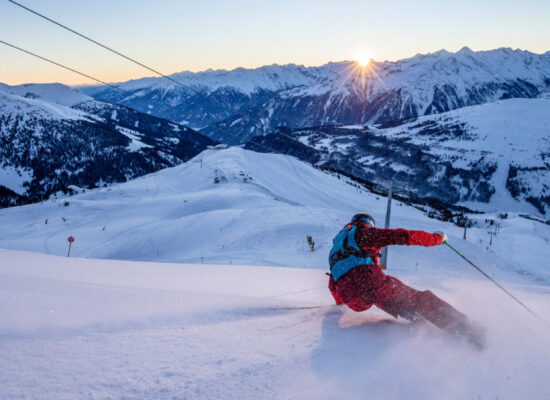 Alpin Luxe Ski Vacations - Skier in the Dolomites at last light