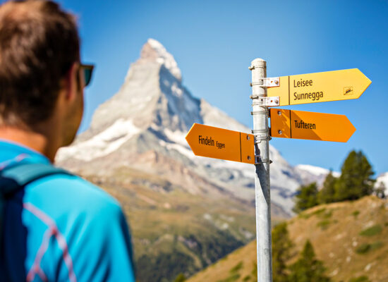 Hiker viewing trail signs in Zermatt