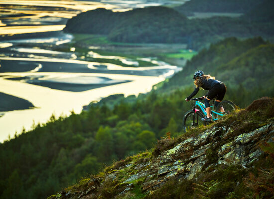 Woman Mountain Biking Downhill in Wales